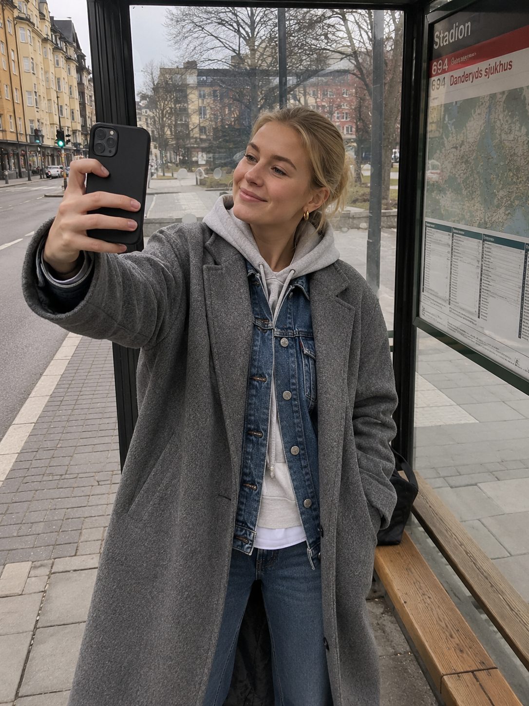 Denim jacket layered under a coat