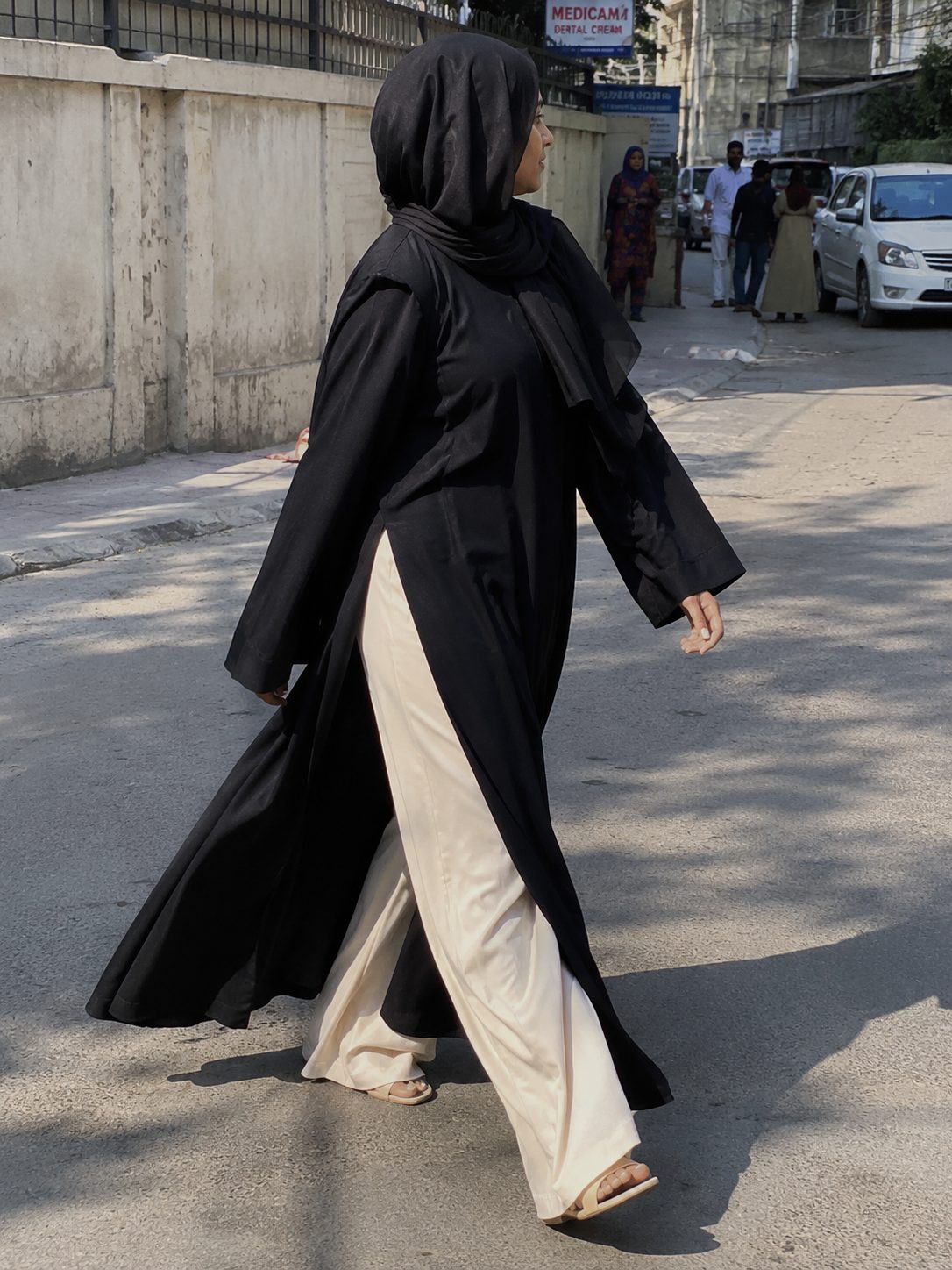 Abaya with side slits over wide-leg pants
