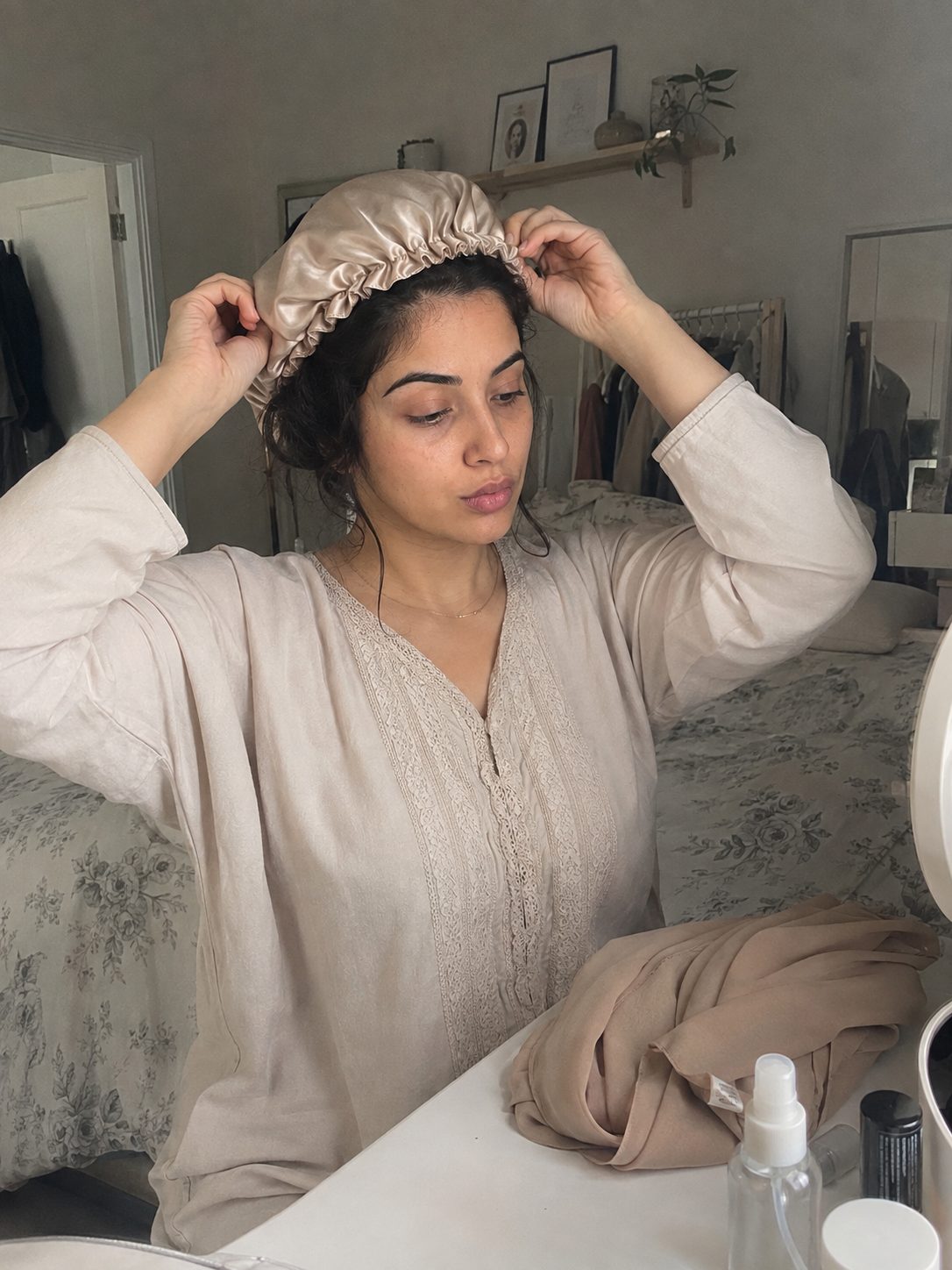 Putting on a silk satin bonnet underneath a hijab underscarf